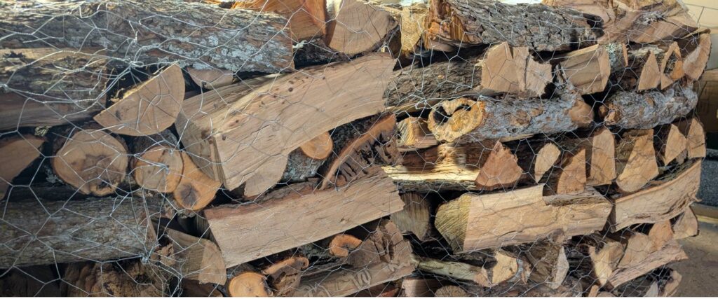 Split firewood stacked for sale